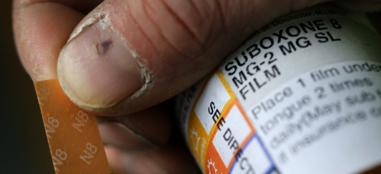 hand holding bottle with Suboxone