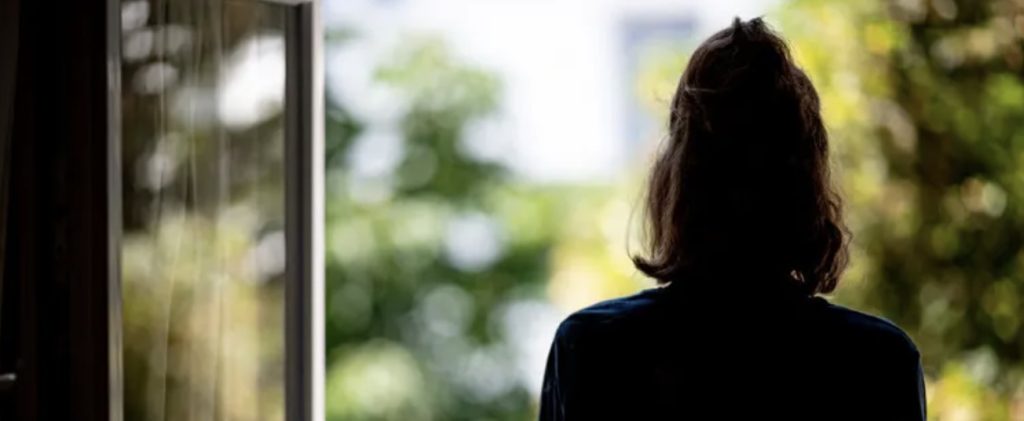 view of girl from behind, looking out window