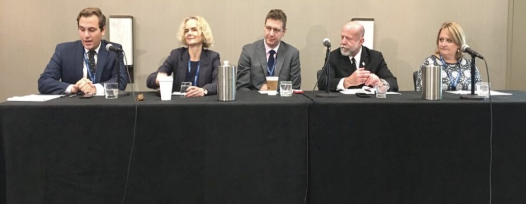 medical news reporter and medical experts speaking from a table