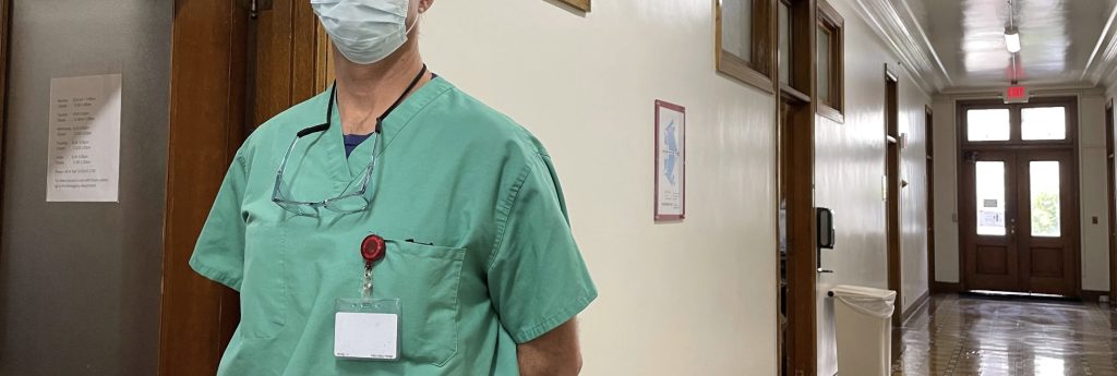 A medical professional standing in a hallway