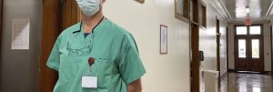 A medical professional standing in a hallway