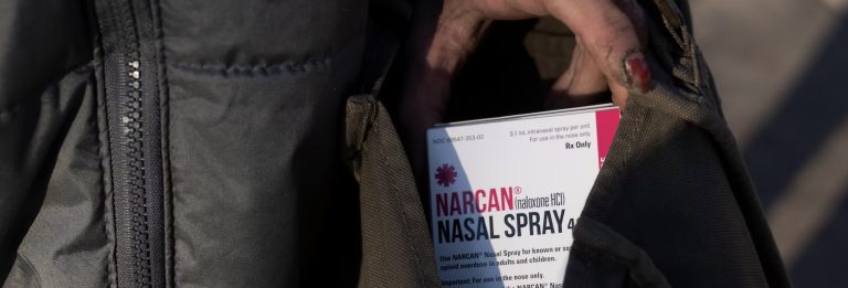 image of a box containing Narcan in someone's jacket pocket