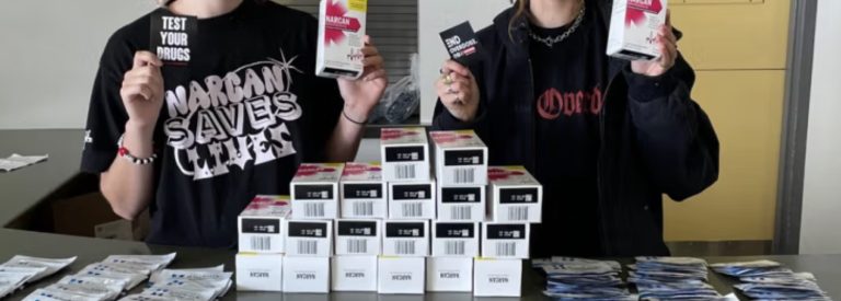 Volunteers with Narcan at a table