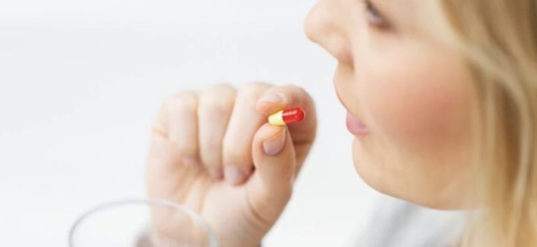 Woman taking a pill