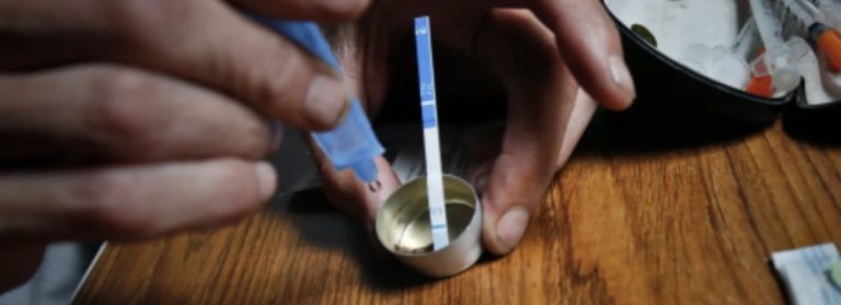 image of a fentanyl test strip being used by a drug user