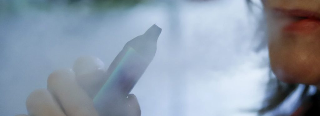 image of young woman vaping