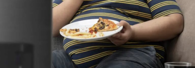 image of an obese child eating high-calorie food